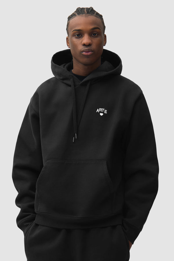 Cor Hoodie in Black worn by a model, half-body front view