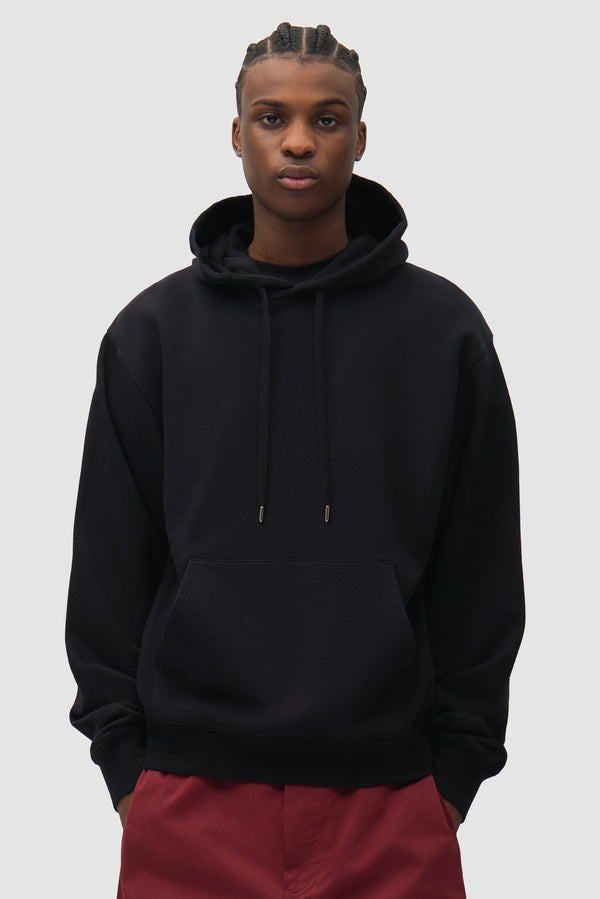City Hoodie in Black worn by a model, half-body front view