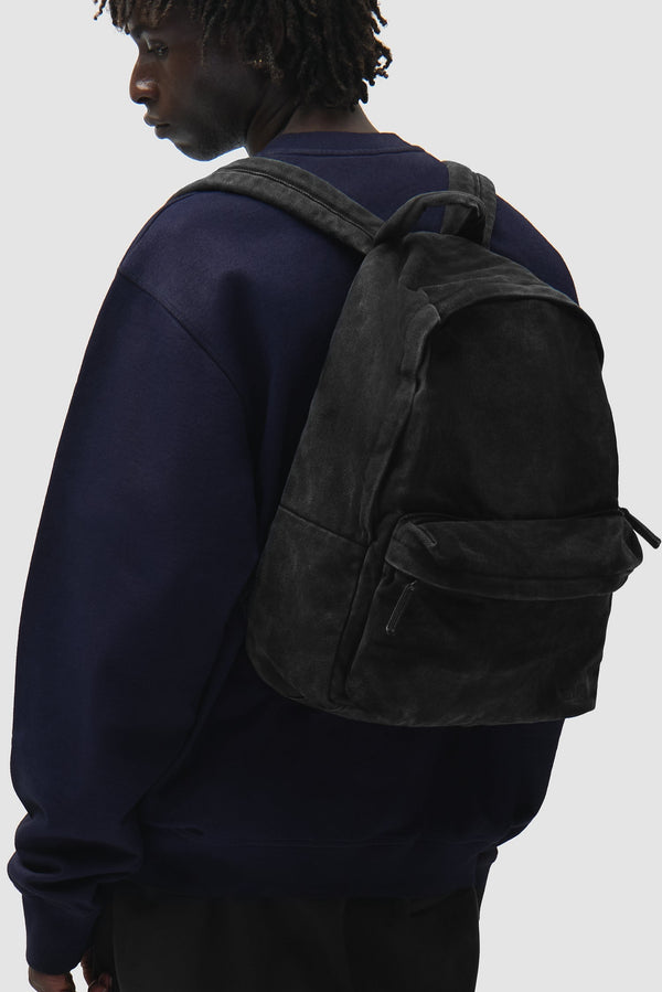 Sunfade Backpack in Black worn by a model, half-body side view