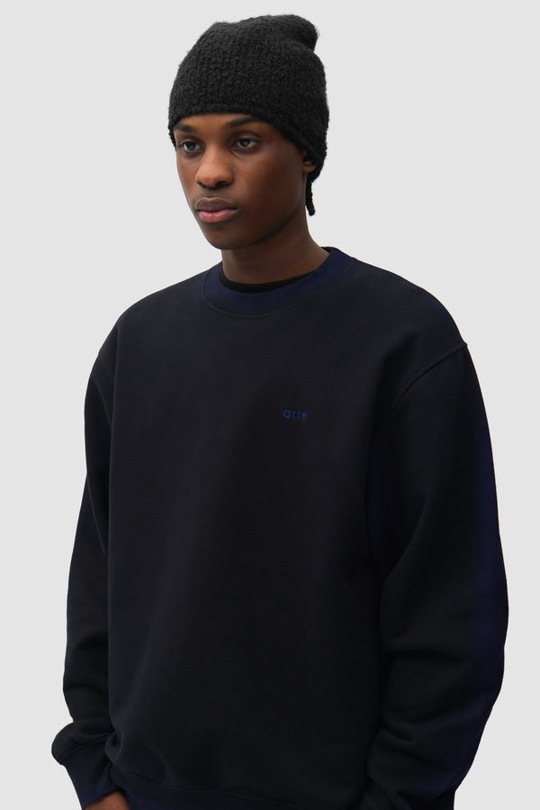 Boucle Beanie in Black worn by a model, half-body front view