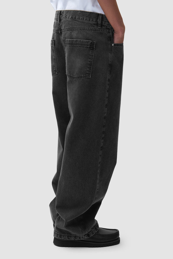 Cor Uniform Denim Pants in Black worn by a model, half-body back view