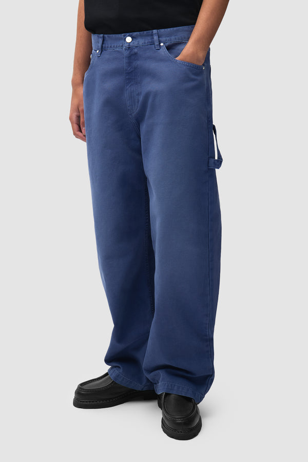 Atelier Uniform Denim Pants in Navy worn by a model, half-body front view