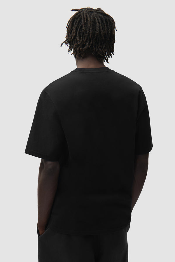 Big A Side T-Shirt in Black worn by a model, half-body back view