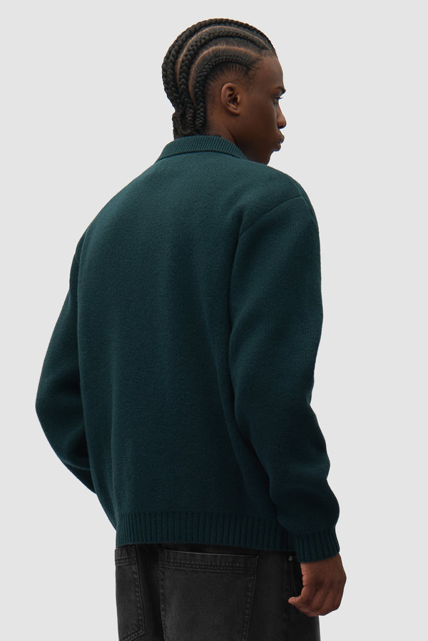 Cable Knit Zip Cardigan in Green worn by a model, half-body back view