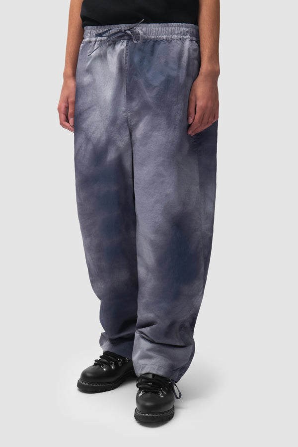 Sunfade Aero Track Pants in Navy worn by a model, half-body side view