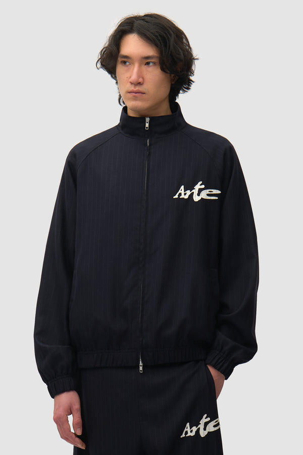 Pinstripe Tracksuit Jacket in Black worn by a model, half-body front view