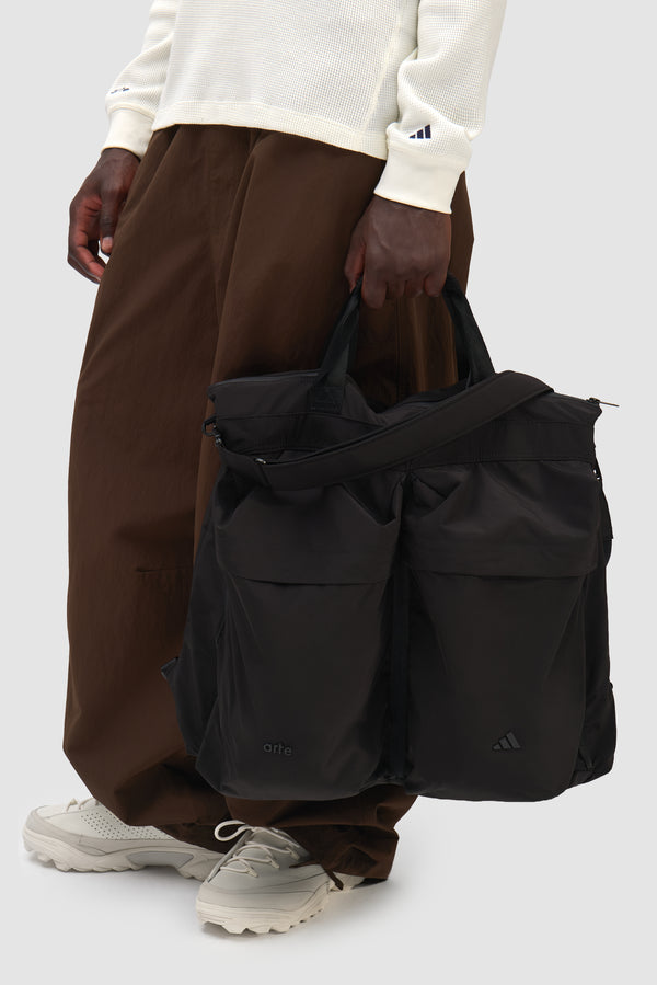Arte for adidas Bag in Black carried by a model, half-body front view