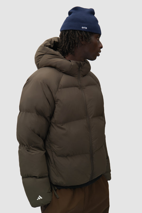 Arte for adidas Beanie in Collegiate Navy worn by a model, half-body side view