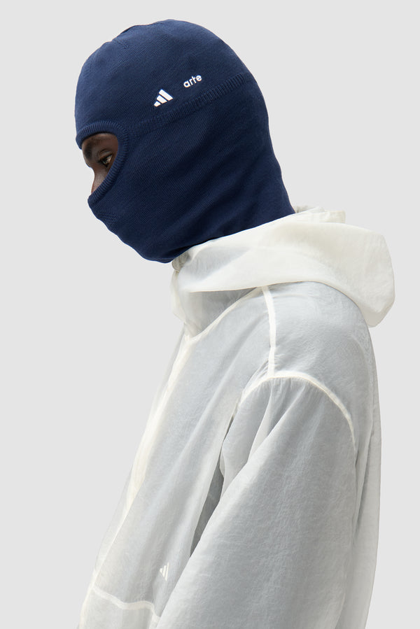 Detail view of Arte for adidas Balaclava in Collegiate Navy, showing adidas logo and striped knit