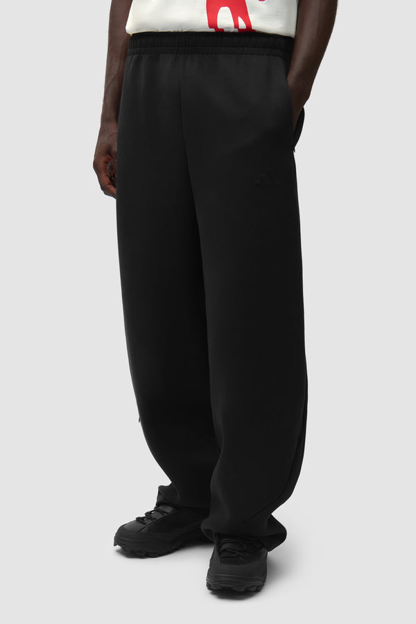 Arte for adidas Z.N.E. Track Pants in Black worn by a model, half-body side view