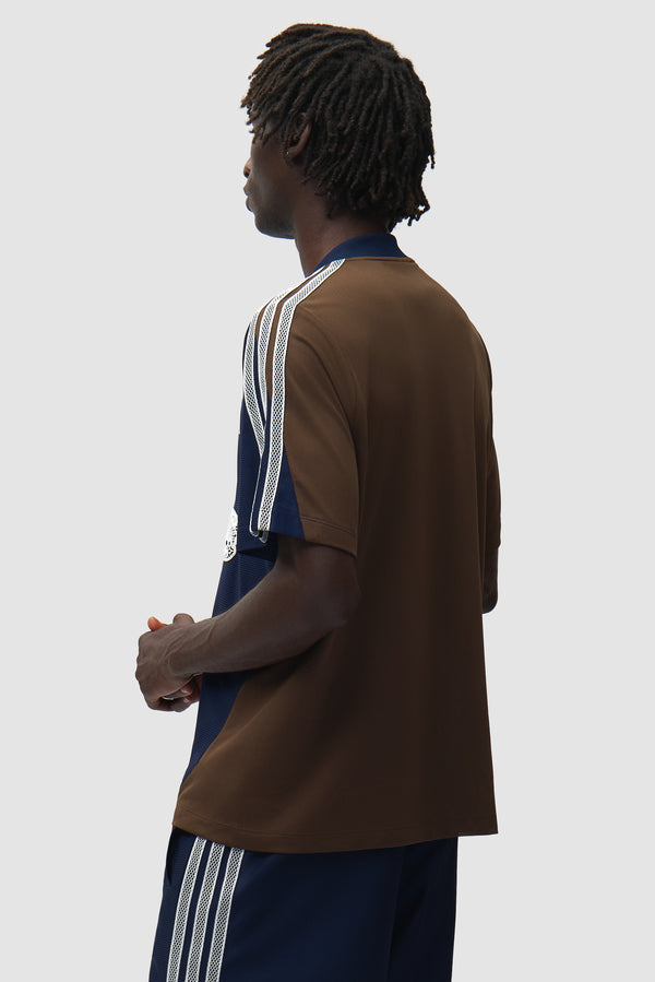 Arte for adidas Jersey in Navy/Brown worn by a model, half-body back view