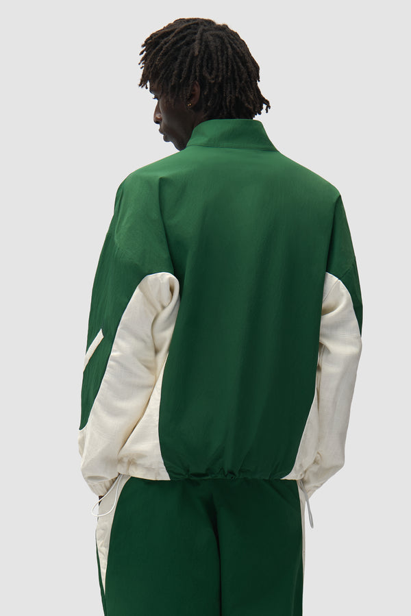 Arte for adidas Z.N.E. track top in Green/Cream worn by a model, full-body back view