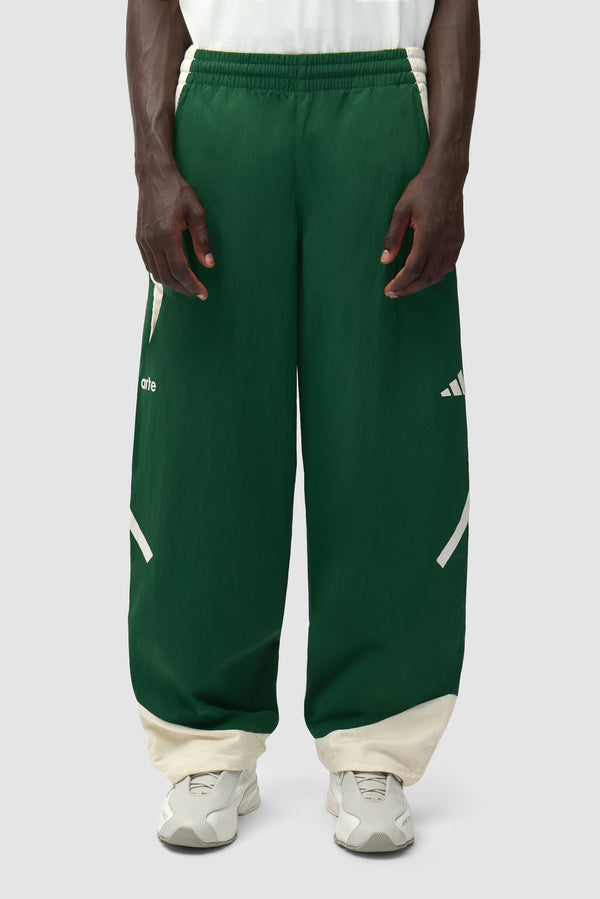 Arte for adidas Z.N.E. track pants in Green/Cream worn by a model, half-body front view