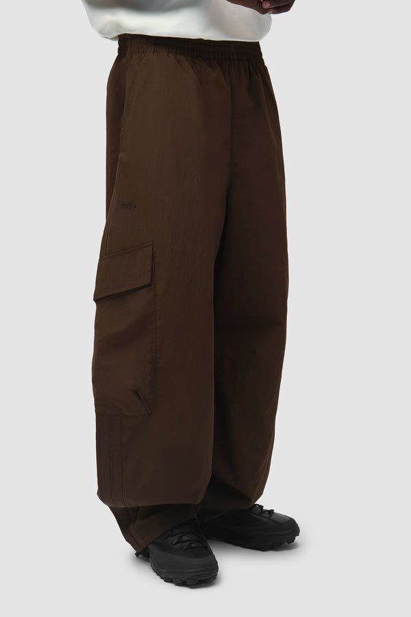 Arte for adidas Cargo Pants in Dust Cargo worn by a model, half-body side view