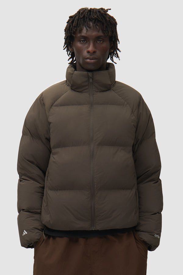 Arte for adidas Puffer in Shadow Olive worn by a model, half-body front view
