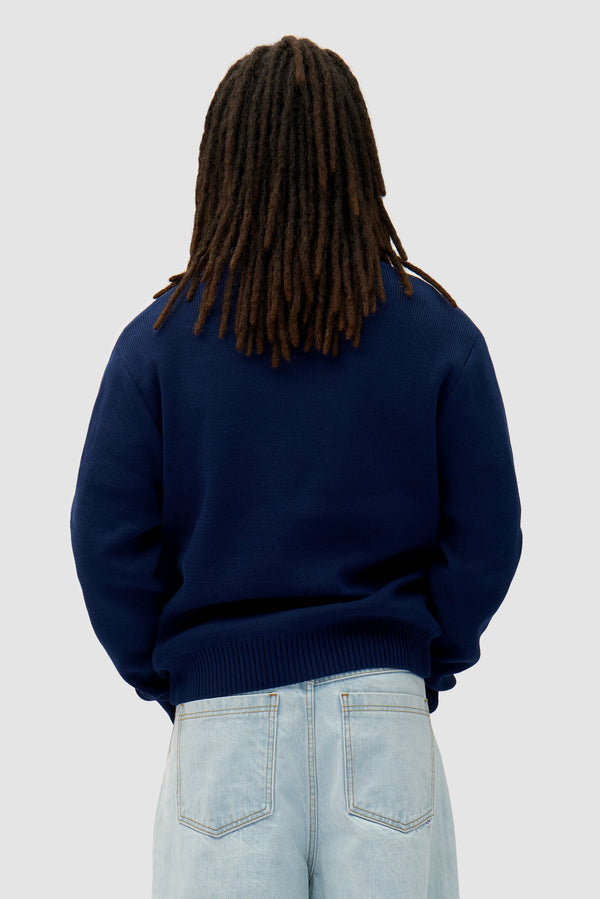 Bird Logo Knit in Navy worn by a model, half-body back view