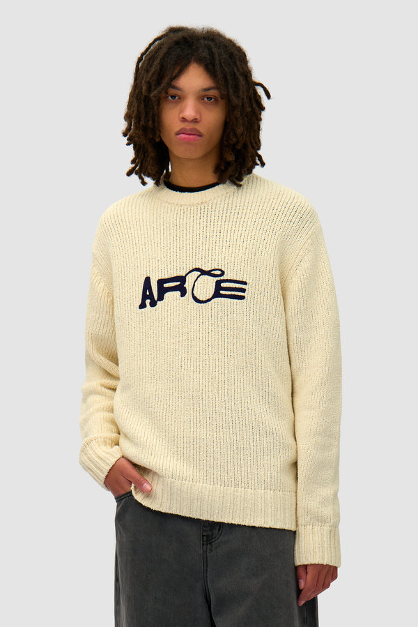 Logo Knit Sweater in Cream worn by a model, half-body front view