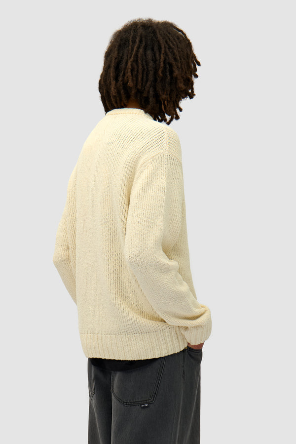 Logo Knit Sweater in Cream worn by a model, half-body back view