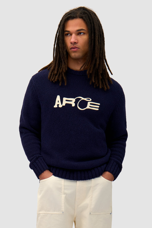 Logo Knit Sweater in Navy worn by a model, half-body front view