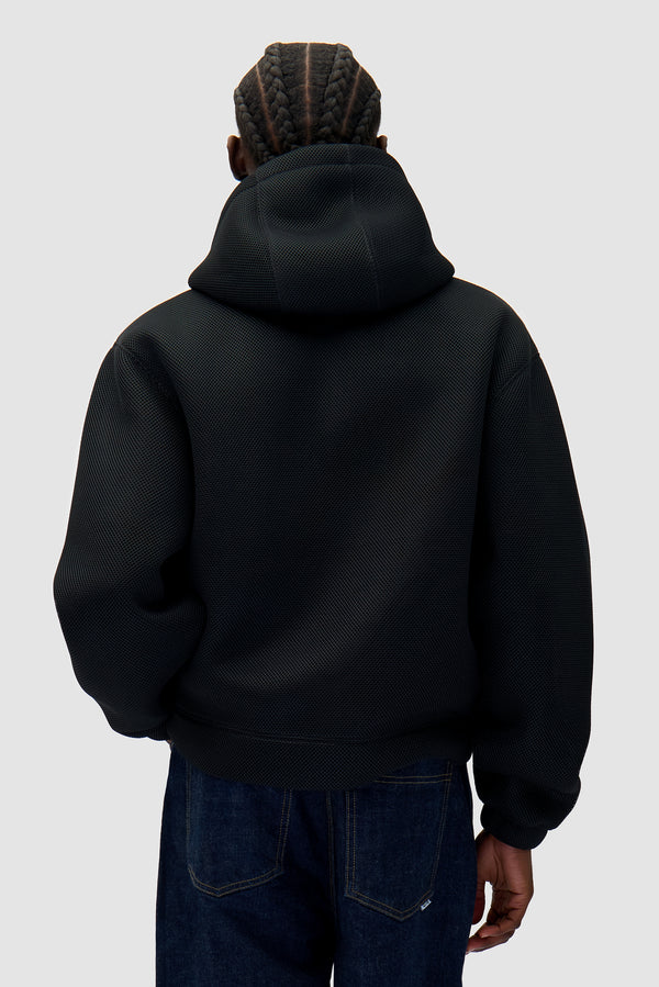 Mesh Hooded Jacket in Black worn by a model, half-body back view