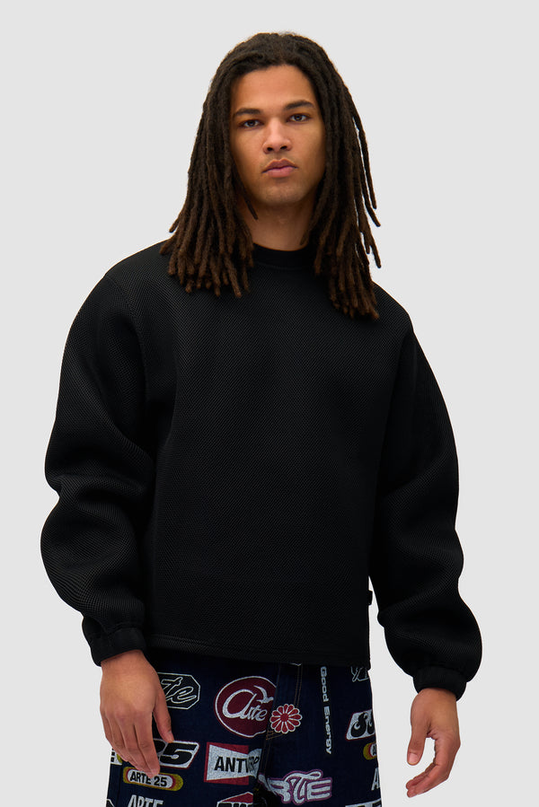 Mesh Crewneck in Black worn by a model, half-body front view