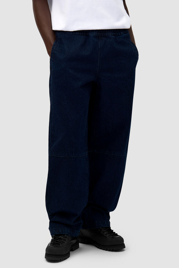 Denim Tech Pants in Navy worn by a model, half-body front view