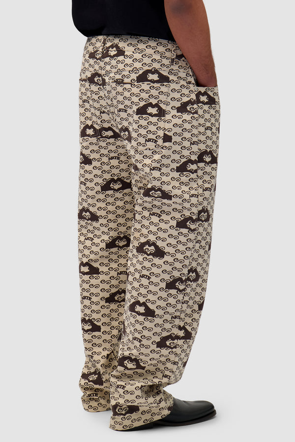 Hand Heart Print Pants in Cream/Brown worn by a model, half-body side view