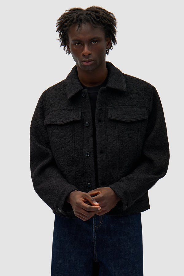 Wool Jacket in Black worn by a model, half-body front view