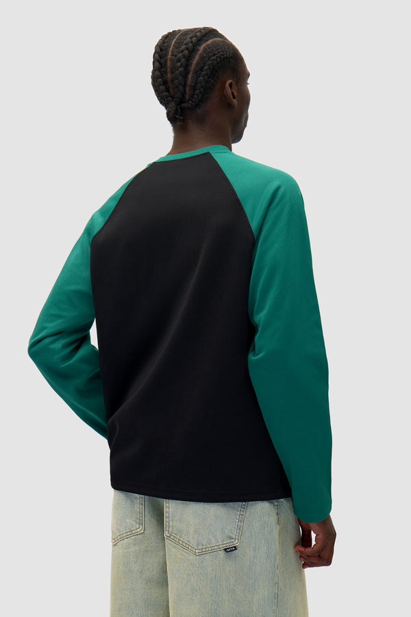 Bird Logo Longsleeve in Green/Black worn by a model, half-body back view