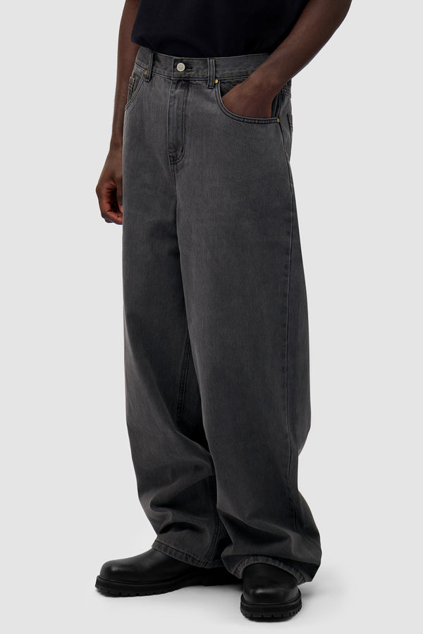 Denim Pants in Fade Black worn by a model, half-body side view