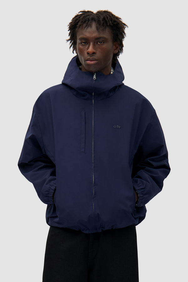 Reversible Plaid Technical Jacket in Navy/Plaid worn by a model, half-body front view, navy side