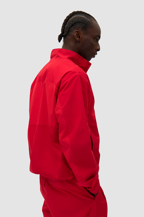 Tracksuit Jacket in Red worn by a model, half-body back view