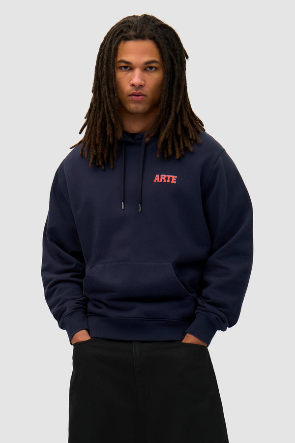 Mural Back Print Hoodie in Navy worn by a model, half-body back view