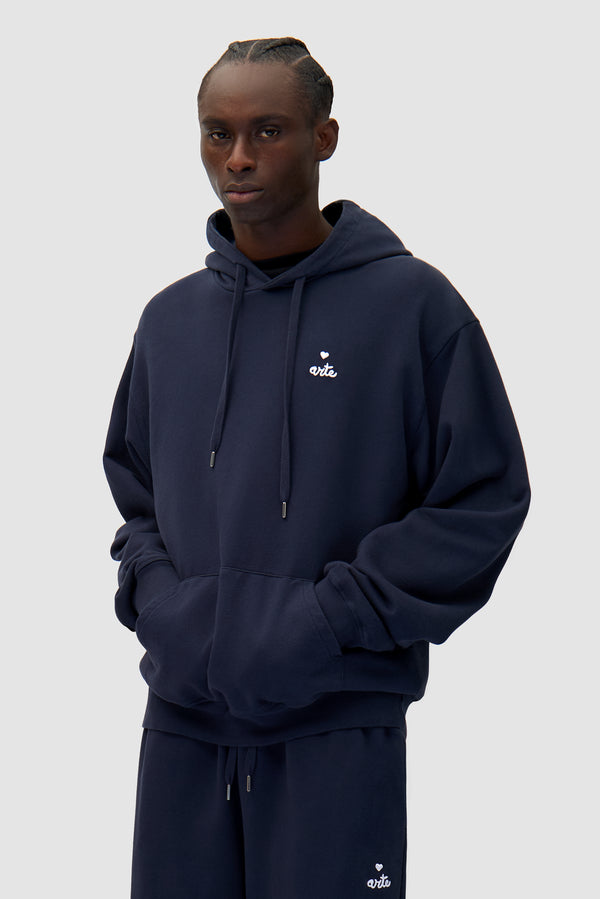 Heart Logo Hoodie in Navy worn by a model, half-body front view