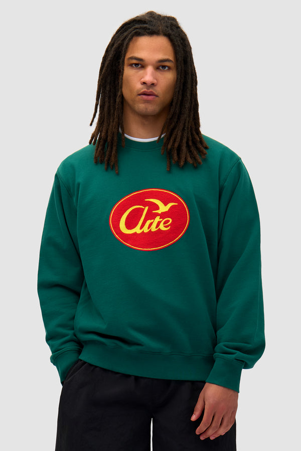 Bird Logo Crewneck in Green worn by a model, half-body front view