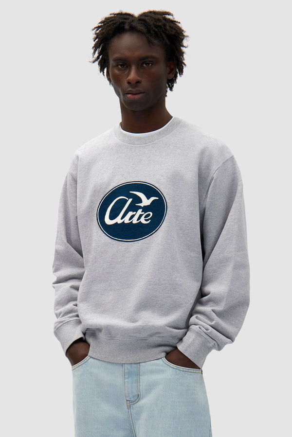 Bird Logo Crewneck in Grey worn by a model, half-body front view