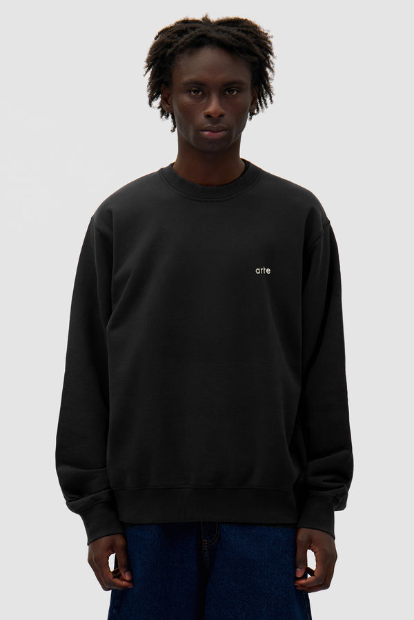 Logo Crewneck in Black worn by a model, half-body front view