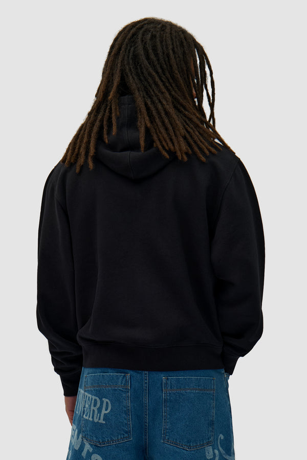 Energy Zip Hoodie in Black worn by a model, half-body back view