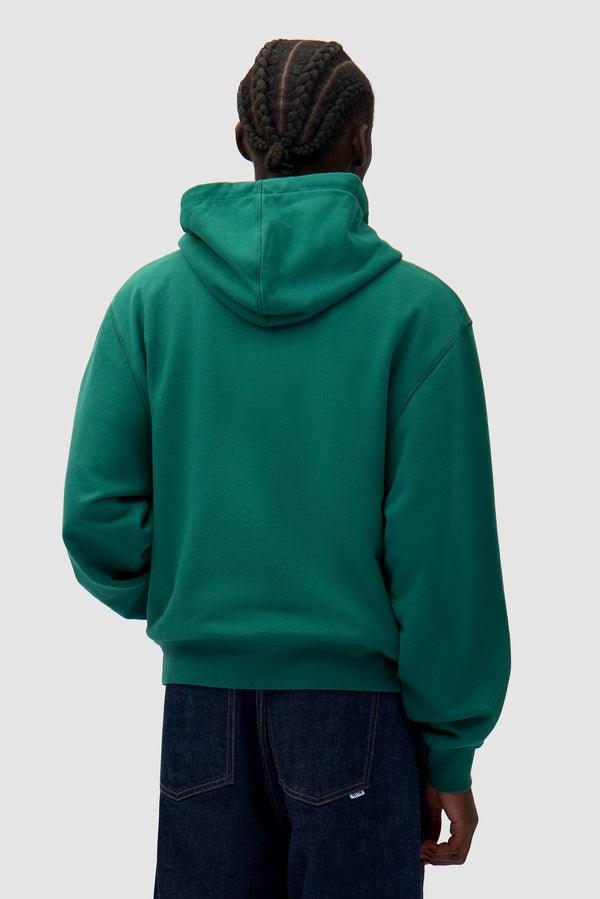 Energy Zip Hoodie in Green worn by a model, half-body back view