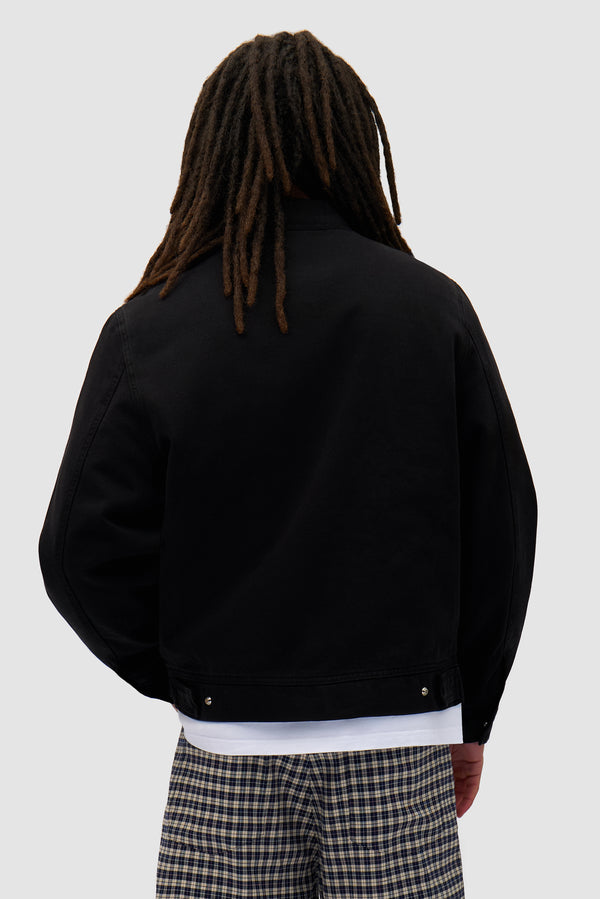 Heart Logo Jacket in Black worn by a model, half-body back view