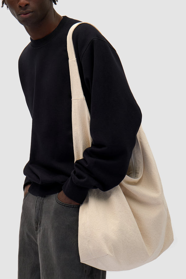 Cotton Bag in Cream worn by a model, half-body front view