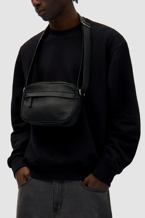 Texture Leather Bag in Black worn by a model, half-body front view