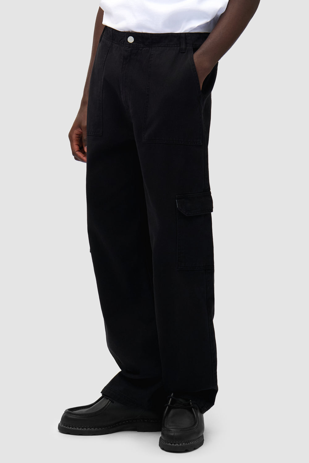 Cargo Pants in Black worn by a model, half-body side view