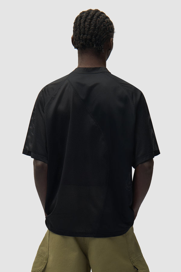 Multi Mesh T-shirt in Black worn by a model, half-body back view