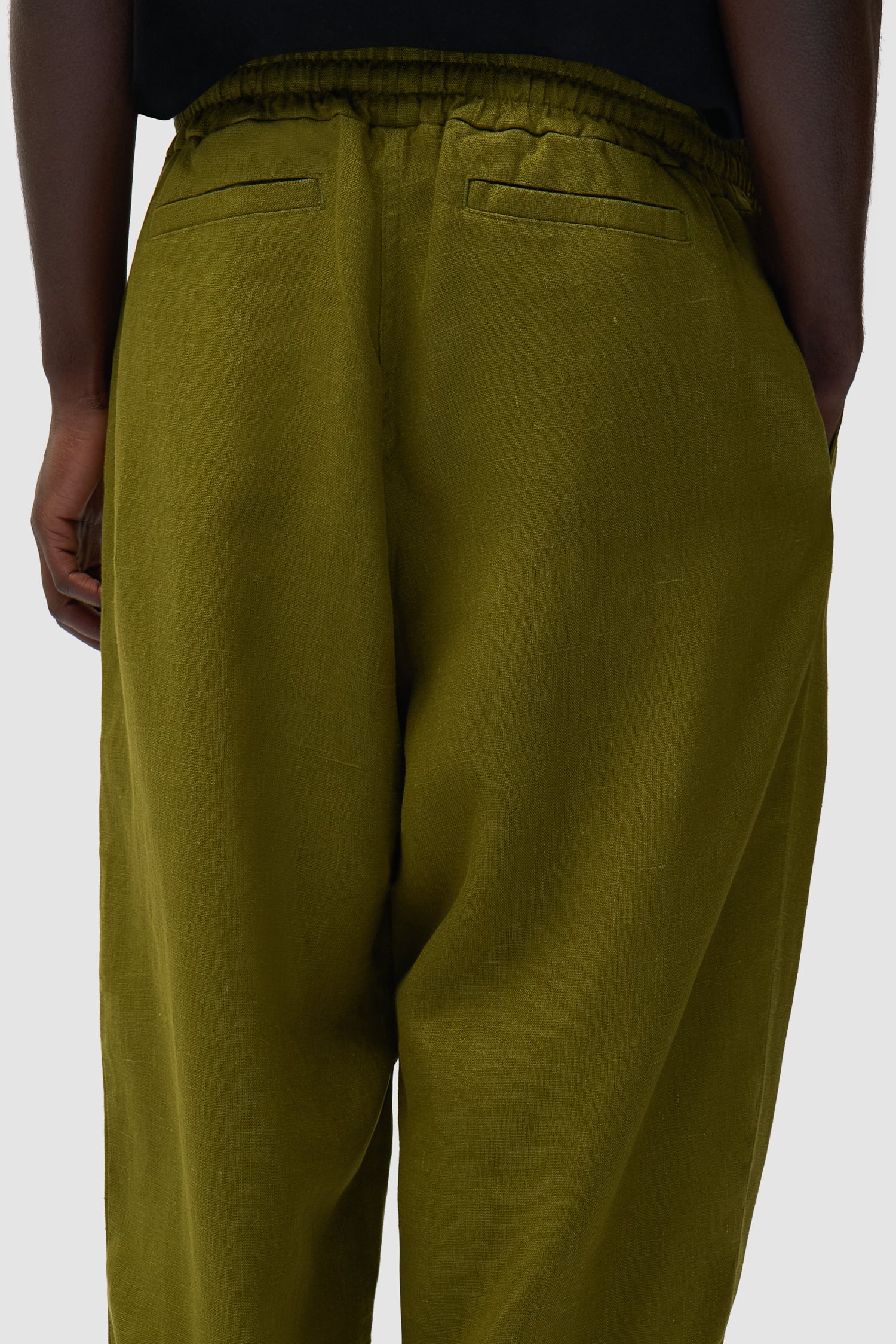 Detail view of Linen Pants in Green, showing back pockets