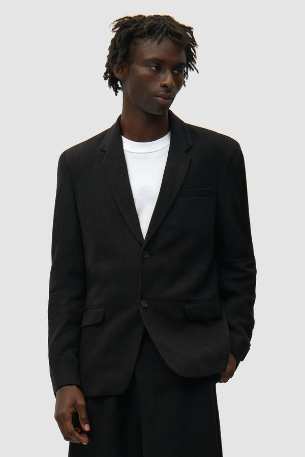 Linen Suit Jacket in Black worn by a model, half-body front view