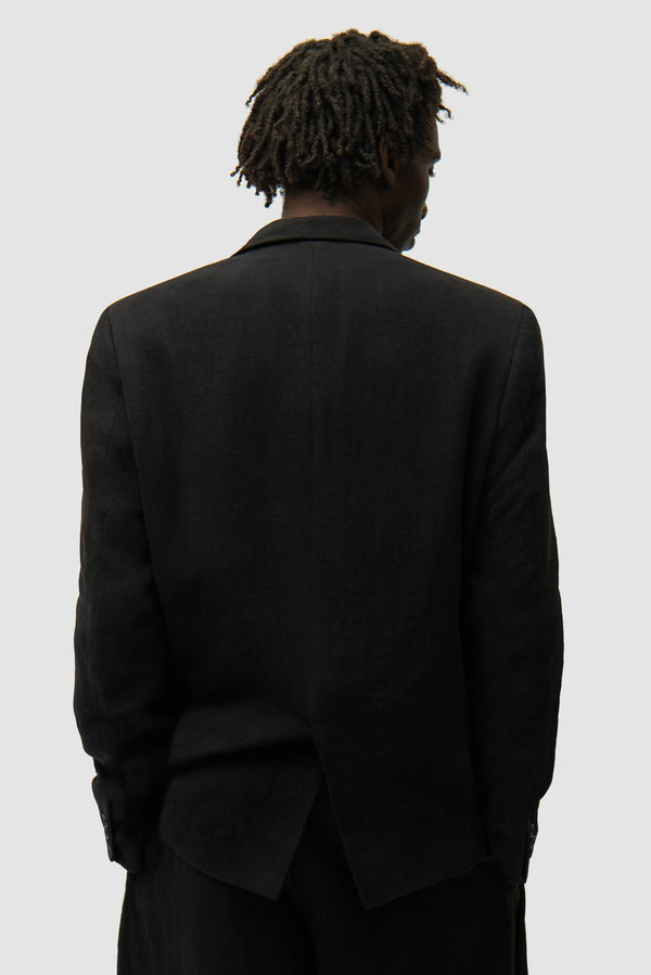 Linen Suit Jacket in Black worn by a model, half-body back view