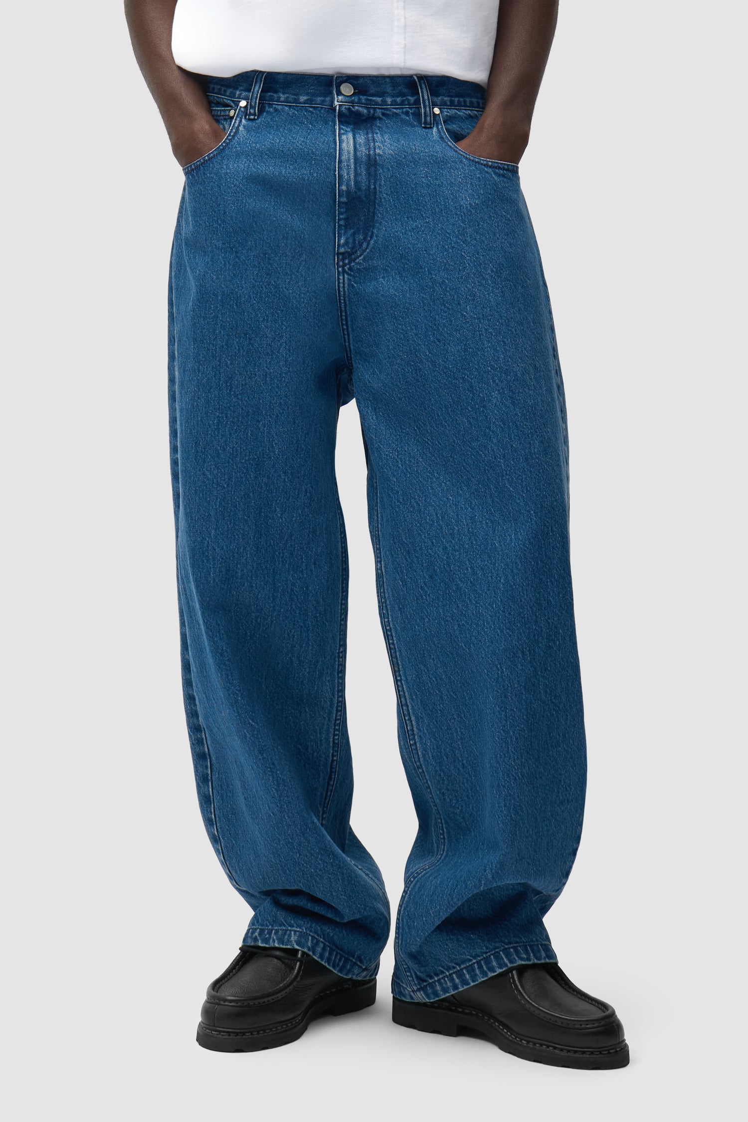 Baggy Pants in Raw Denim worn by a model, half-body front view