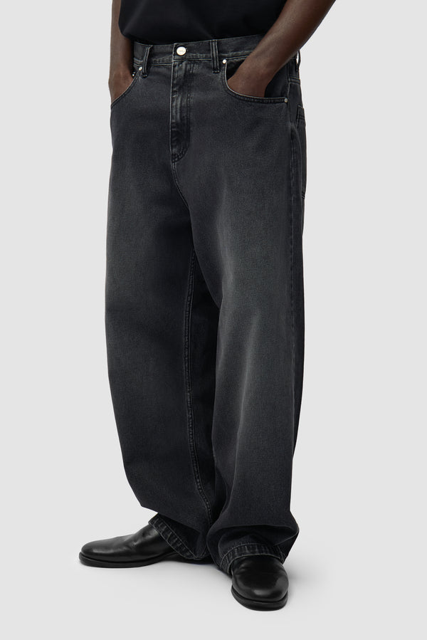 Fade Wash Baggy Pants in Black worn by a model, half-body side view