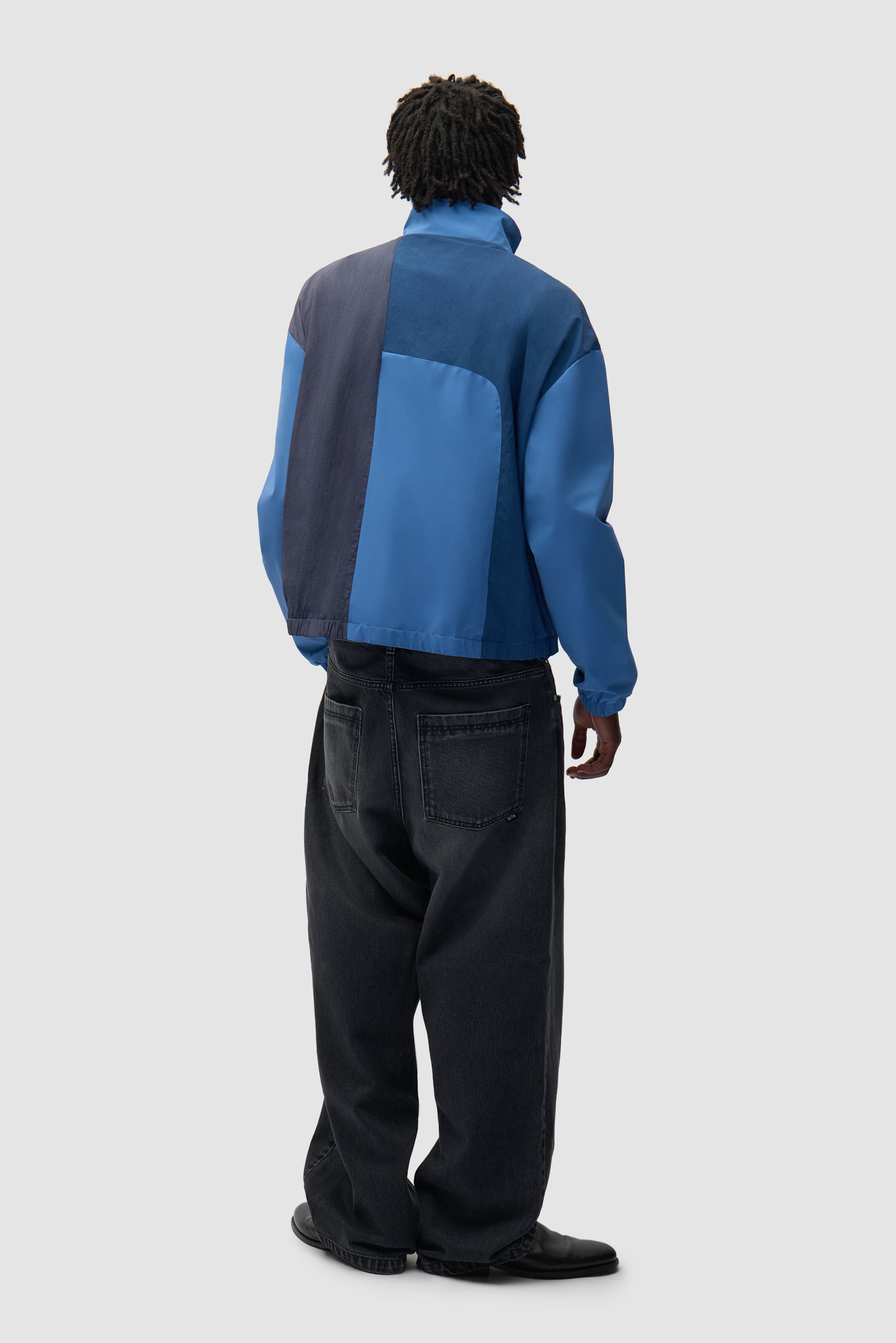 Curve Zipper Jacket in Blue worn by a model, full-body back view